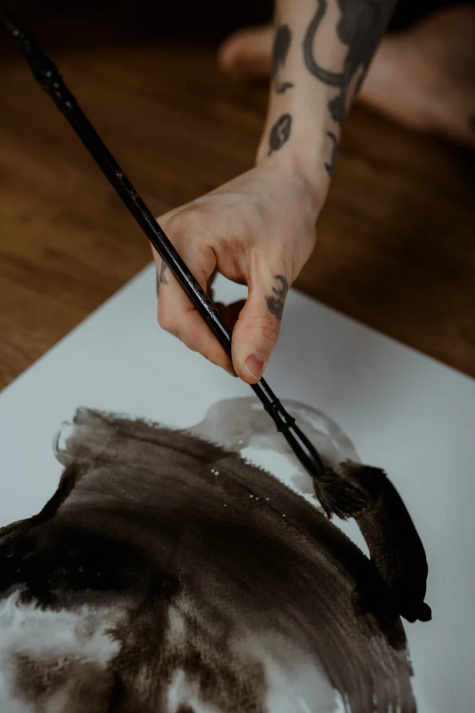 Agnes Hayden doing one of her abstract ink paintings.