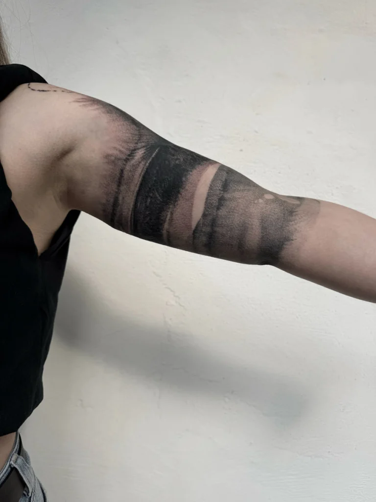 Abstract tattoo on an upper arm, done free-hand by Agnes Hayden.